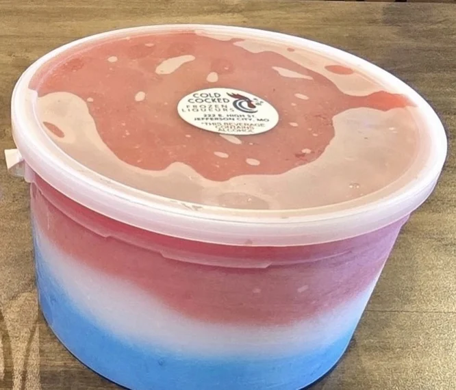 Red white and blue layered Cold Cocked frozen drink in a gallon to-go bucket